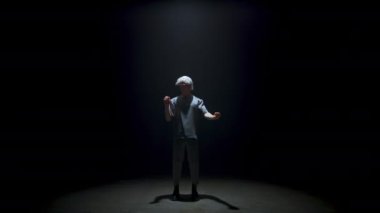 Man enjoying virtual reality simulation in goggles. Focused gamer selecting invisible digital objects in dark room. Metaverse guy immersing hi tech world in light. Futuristic performance concept.
