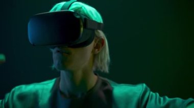 Vr goggles gamer enjoying innovation data cyberspace closeup. Man glasses taking new experience in virtual world in neon light. Global Internet connection and futuristic technology of metaverse