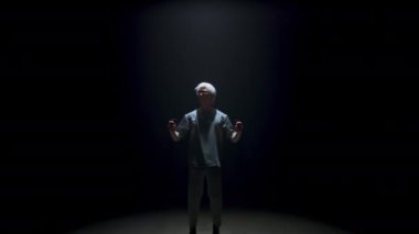 Guy using virtual reality controllers headset in dark room. Futuristic man play console simulation online game in light. Focused blonde gesture wear digital glasses. Metaverse technology entertainment