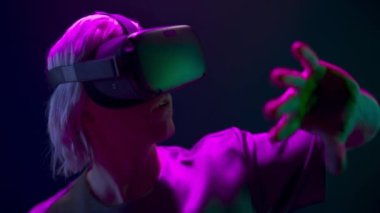 Closeup man hands touching virtual global internet connection space. Metaverse person VR glasses exploring analyzing invisible videogame world neon light. Data and future digital technology concept 