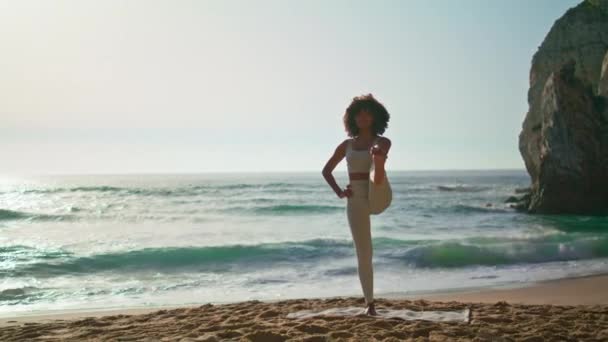 Kobieta Yogi Ćwiczy Pozę Balans Ćwicząc Plaży Świcie Afroamerykańska Sportowa — Wideo stockowe