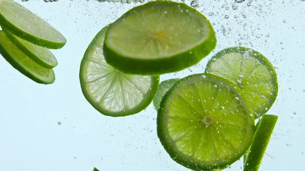 Świeże Zielone Limonki Pod Wodą Białym Tle Blisko Dojrzałe Kwaśne — Zdjęcie stockowe