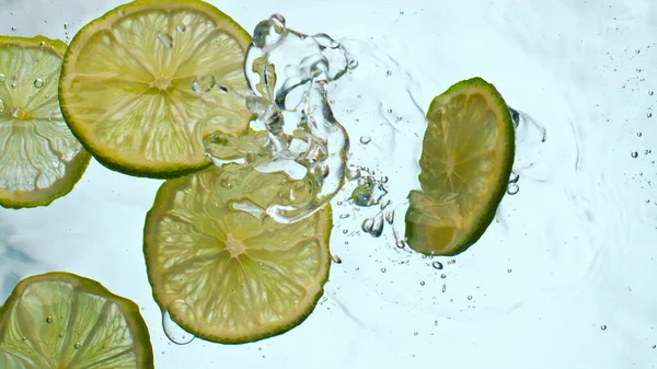 Fresh Lime Slices Falling Clear Water Super Slow Motion Close — Stock Photo, Image