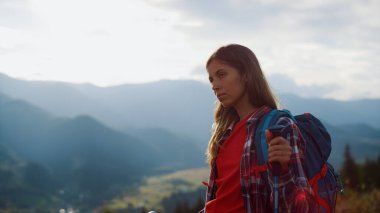 Closeup tired traveler going holiday nature. Beautiful woman wear backpack in mountains hike trail. Relaxed girl hiking on adventure. Thoughtful tourist spend summer vacation. Freedom active concept.