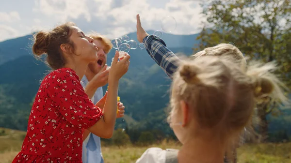 Happy Family Playing Blowing Soap Bubbles Summer Mountains Closeup Joyful — Stock Fotó