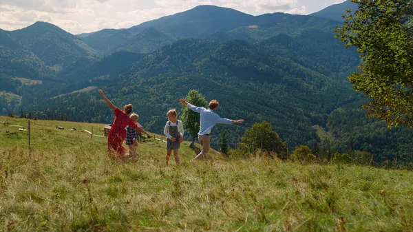 Cheerful Family Playing Active Games Green Grass Mountain Slope Playful — Foto de Stock