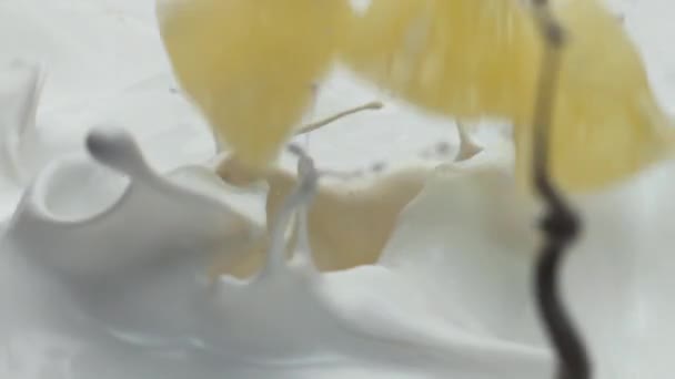 Sliced Sweet Pineapple Falling Fresh Milk Making Splashes Super Slow — Stock Video