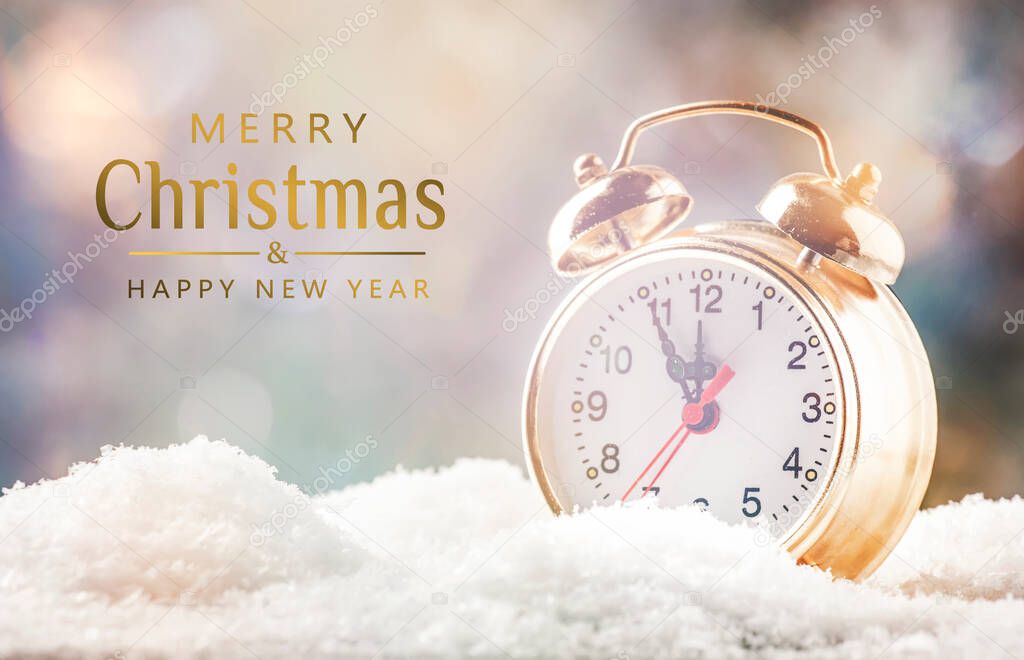 Merry and Happy New Year background with text. Golden alarm clock in snowdrifts on blue background with holiday lights counting last moments before Christmas