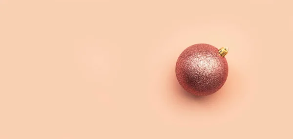 淡いピンクの背景に光沢のあるピンクのクリスマスボール コピースペースバナー — ストック写真