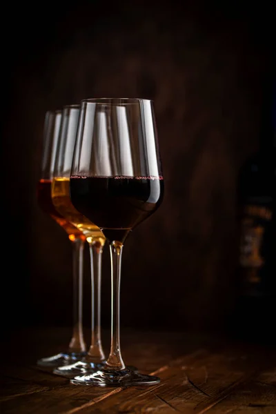 木製の背景とワインボトルのコレクションのガラスで赤 バラのワイン コピースペース — ストック写真