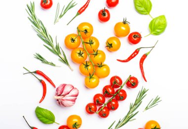 Spicy herbs and vegetables. Tomato, basil, rosemary, pepper, garlic on white background. Cooking concept, top view, copy space