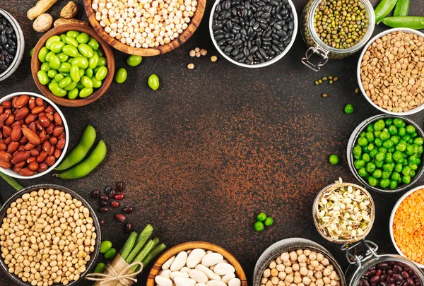 Legumes, beans and sprouts. Dried, raw and fresh, top view. Red beans, lentils, mung beans, chickpeas, soybeans, edamame, green peas, Healthy diet food, vegan protein, micronutrients fiber sources