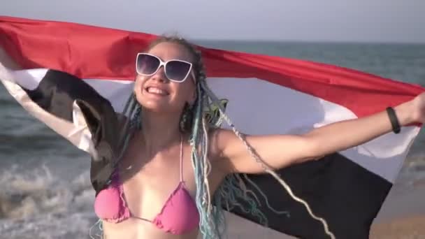 Mulher atraente em um maiô na praia do mar com a bandeira do Egito, close-up — Vídeo de Stock