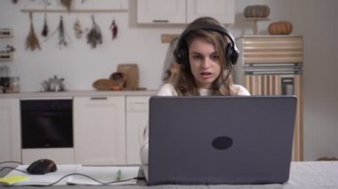 Genç işletme öğretmeni kız öğrenci öğretmenleri kablosuz video konferansı giyer. Bilgisayarla konuşur, web kamerasıyla konuşur, online sohbet öğretir, uzaktan ağ öğretim kavramını öğretir.