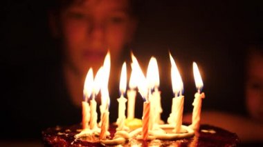 Doğum gününde bir çocuk pastadaki mumları üflüyor. 10 yıl.