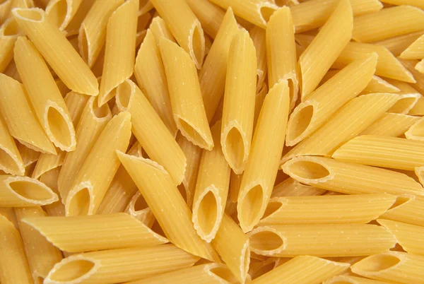 Italian penne rigate pasta background. Pasta and bakery