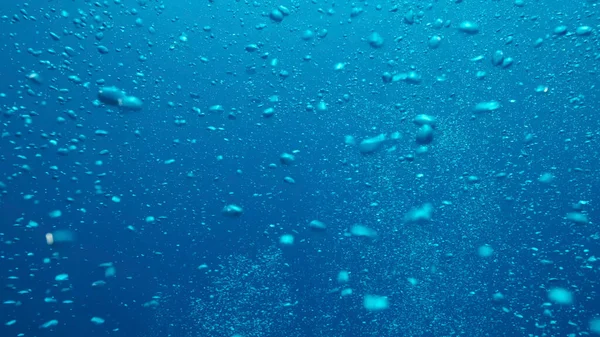 Air bubbles floating from sea bottom to the water surface. Air bubbles in the blue water. Mediterranean Sea, Cyprus