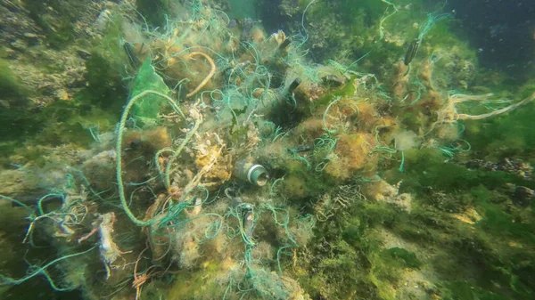 Lost fishing gear lies underwater on the seabed. Problem of ghost gear - any fishing gear that has been abandoned, lost or otherwise discarded. It is the most harmful form of marine debris