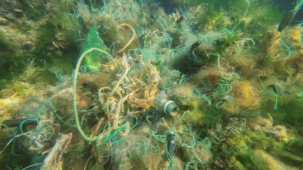 Lost fishing gear lies underwater on the seabed. Problem of ghost gear - any fishing gear that has been abandoned, lost or otherwise discarded. It is the most harmful form of marine debris