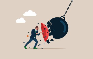Businessman holding an open red umbrella which protects from a collision with a broken wrecking ball. Safety measures. IT defense. Insurance and protection. 