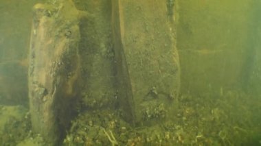 Archaeological research: camera slowly rises along the frame to which the side boards are attached, Dnieper River, Ukraine.