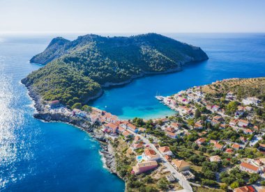 Assos, Yunanistan 'ın Kefalonia kentinin yukarısından güzel bir balıkçı köyü. Hava aracı görüntüsü. Yelkenli tekneler turkuaz körfezde demirlemiş..