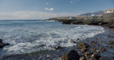 Puerto de la Santiago, Tenerife. Punta Blanca or Punta Juanita - best place to surf or chill relax. Black rocky volcanic beach. Coast of the Atlantic Ocean