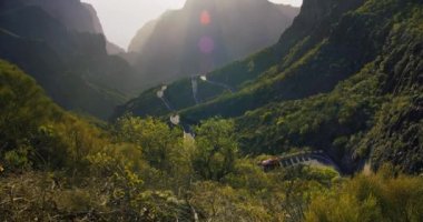 The road in the mountains leading to the Mask Gorge or Masca Gorge on the island of Tenerife. Spain. View on the mountains and gorge during sunset. Nobody.