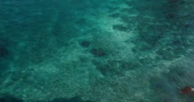 Blue azure turquoise sea water texture, a view and background of transparent clear ocean surface. Nobody. Coastal current. Deep sea bottom. Sunny day,