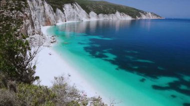 Amazing aerial view of Idyllic tropical beach with calm turquoise water. HD video of caribbean sea with white sand shore. Concept of recreation and leisure. Summertime, summer vacation and travel in