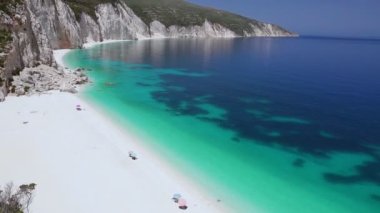 HD panning shot video of beautiful white beach with calm clear blue turquoise sea water. White paradise beach, summer feeling, vacation, travel in paradise. Amazing Ftery beach, kefalonia, Greece