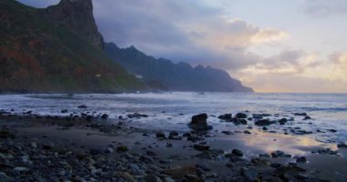 Rocky coastline alongside cliffside with blue Atlantic Ocean at sunset. Benijo Beach in Tenerife, Canary Islands, Spain. Nobody.