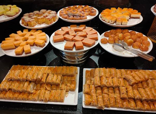 Food on the shelves in the self-service buffet with all inclusive in Turkey at abstract hotel or resort at Kemer. Sweet cakes and dessert