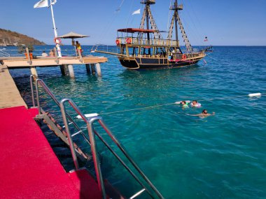 Tekirova, Antalya, Türkiye - 11 Mayıs 2021: Akdeniz Körfezi, Türkiye 'de eski bir yat ve eğlenceli güneşle.