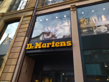 Strasbourg, Alsace, Fransa - 30 Aralık 2021: Dr. Martens şehirde bir mağaza. Dükkanın önünde büyük sarı ışıklı harfler var. Uluslararası şirket logosu.