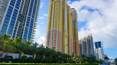 Miami, USA - April 24, 2022: Modern apartment buildings with palm trees at Avenue at Miami, Usa