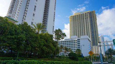 Miami, USA - April 24, 2022: Modern apartment buildings with palm trees at Avenue at Miami, Usa