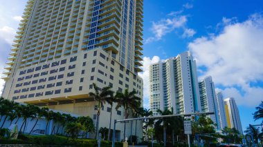 Miami, USA - April 24, 2022: Modern apartment buildings with palm trees at Avenue at Miami, Usa
