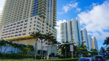 Miami, USA - April 24, 2022: Modern apartment buildings with palm trees at Avenue at Miami, Usa