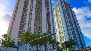 Miami, USA - April 24, 2022: Modern apartment buildings with palm trees at Avenue at Miami, Usa