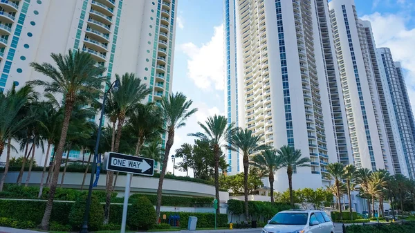 Miami, USA - April 24, 2022: Modern apartment buildings with palm trees at Avenue at Miami, Usa
