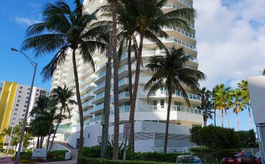 Miami, USA - April 24, 2022: Modern apartment buildings with palm trees at Avenue at Miami, Usa