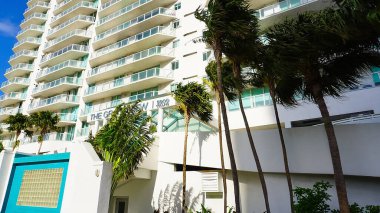 Miami, USA - April 24, 2022: Modern apartment buildings with palm trees at Avenue at Miami, Usa