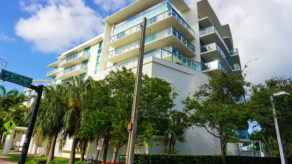Miami, USA - April 24, 2022: Modern apartment buildings with palm trees at Avenue at Miami, Usa