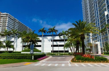 Miami, USA - April 24, 2022: Modern apartment buildings with palm trees at Avenue at Miami, Usa