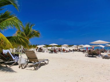 Ocean Cay, Bahamas - May 04, 2022: People resting at Beach on Ocean Cay Bahamas Island with palm trees and tropic background