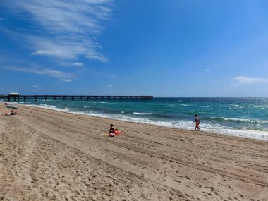 Dania beach, Florida, USA - May 09, 2022: Long distance view of the sunny and tropical blue water shoreline at Dania beach