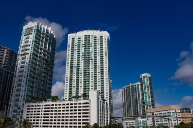 Miami, USA - April 23, 2022: Downtown Miami cityscape view with condos and office buildings against blue sky.