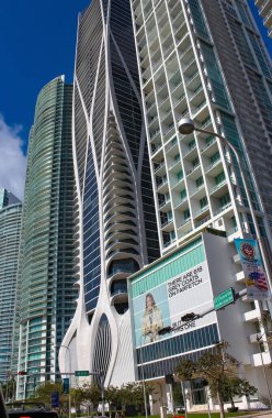 Miami, USA - April 23, 2022: Downtown Miami cityscape view with condos and office buildings against blue sky.