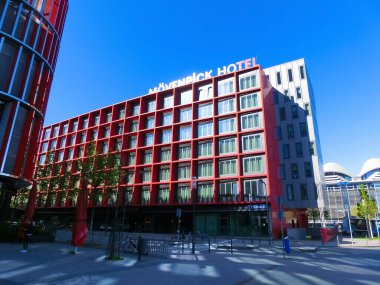 Frankfurt am Main, Germany - May 10, 2022: The silver-red reflective windows facade of modern the Movenpick Hotel